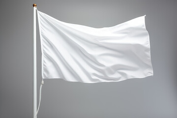 Closeup of a white flag waving on a flagpole against a gray background isolated  - obrazy, fototapety, plakaty