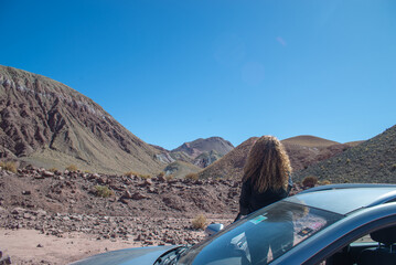 black drerssed woman looking at the wonderful landscape in Atacama