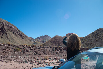 black dressed woman focusing  before shot in valle arcoiris, antofagasta, atacama, chile