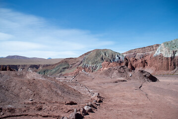 green rocks with a blue sky in the background, antofagasta, atacama, chile