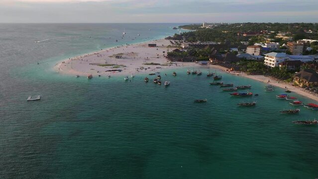 Aerial view of sandy  beach with boats and people background,,Zanzibar, Tanzania