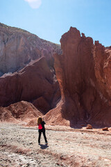 woman taking pictures at the rocks  of the  Valle Arcoiris, Antofagasta, Atacama desert, Chile