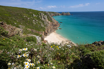 Beautiful calm day from the south west coast path in Cornwall at Portcurno looking towards Logan Rock from Carn Kizzie.