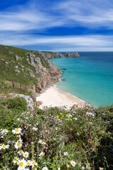 Beautiful calm day from the south west coast path in Cornwall at Portcurno looking towards Logan Rock from Carn Kizzie.