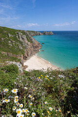 Beautiful calm day from the south west coast path in Cornwall at Portcurno looking towards Logan Rock from Carn Kizzie.