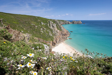 Beautiful calm day from the south west coast path in Cornwall at Portcurno looking towards Logan Rock from Carn Kizzie.