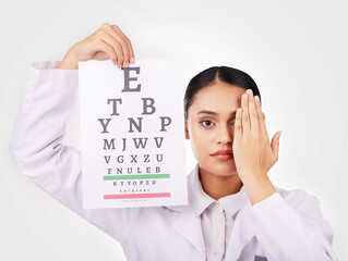 Portrait, poster and eye test with a woman optician in studio on a white background for vision or...