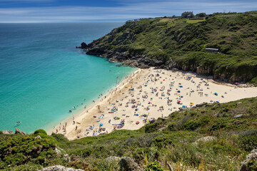 Beautiful calm day from the south west coast path in Cornwall at Portcurno looking towards Logan Rock from Carn Kizzie.