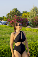 Naklejka na ściany i meble woman in bikini in sunglasses smiling at camera