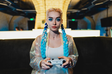Portrait of a young female gamer playing console. © callisto