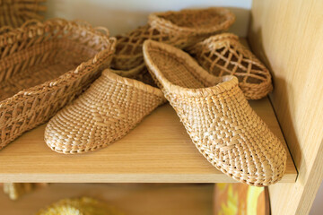 Woven straw slippers. Background with selective focus and copy space