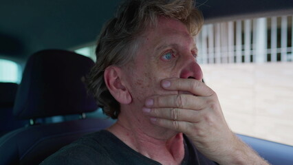 Preoccupied senior man in distress struggles with depression and solitude inside car. Overwhelmed...