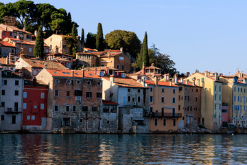 Fototapeta na wymiar The old town of Rovinj with the church of St. Euphemia seen from the sea on a sunny day with blue sky