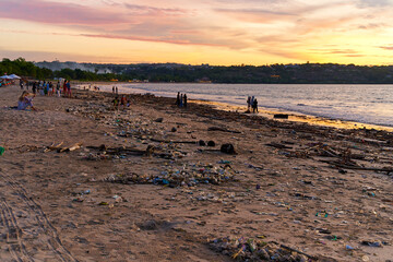 Mountains of waste and garbage on the sandy beach after the tide. Humanity is polluting the ocean