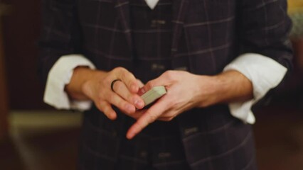 Magician illusionist with a deck of cards showing card tricks focus in front of wealthy rich guests on party event wedding celebration, juggler show, prestidigitator performance on stage