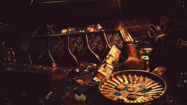 treasures in a dark cave with coins diamonds and gold
