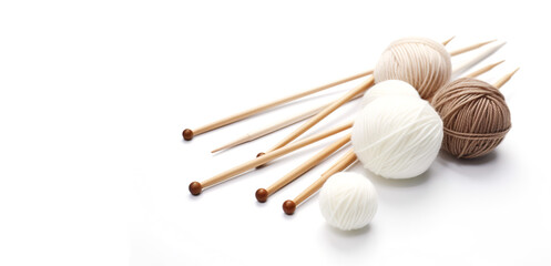 Knitting needles and balls of yarn on a white background with copy space. Hand knitting set with place for text.