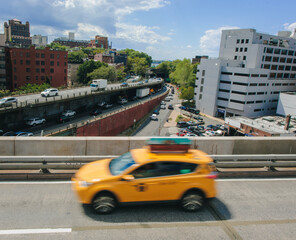 Yellow Taxi on a city bridge