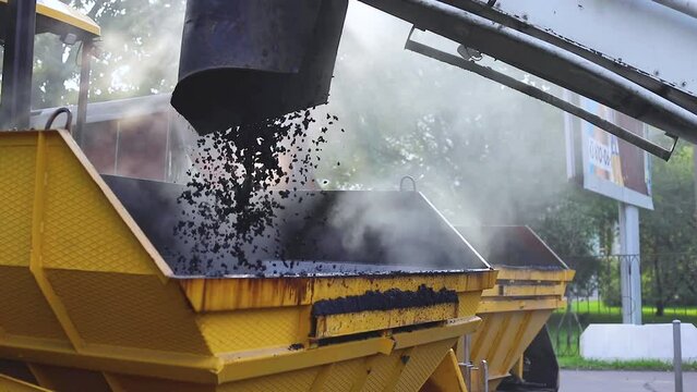 Process of asphalting, blacktopping and paving, asphalt paver machine and steam roller compactor during construction and repairing works, workers on the construction site, rental vehicle working
