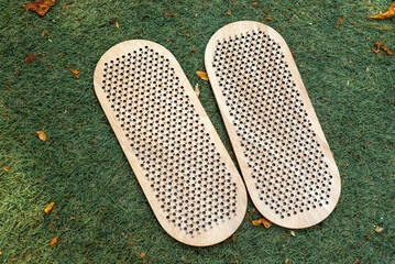Board with nails for yoga practice on a green lawn. top view