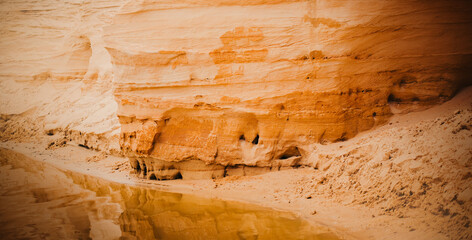 The sandy hills resembling canyons near a body of water. The essence of a summer vacation spent in beautiful locations. The  natural wonders, outdoor recreation, and travel experiences.