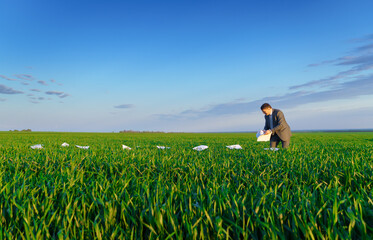 businessman lays out reports on a green grass field, the concept of work and freelancing