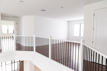 Modern white wooden staircase in new house interior with big windows