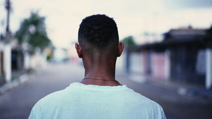 One pensive black man walking forward in street in deep mental reflection and worried emotion....