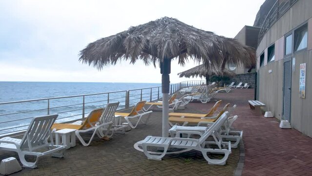 Deck chairs and parasols on Praia do Garajau