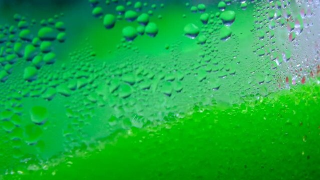 Drops of condensation on the ice cream tank. Ice cold sorbet machine mixing fruit juice. Freezing slush spinning around, summer treat. Crushed iced coloured with fruit flavor sweeteners 