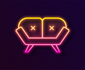 Glowing neon line Sofa icon isolated on black background. Vector