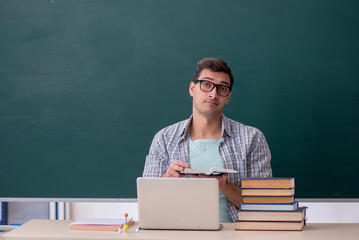 Young male student sitting in the classroom