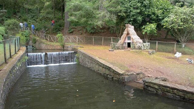 Traditional countryside cottage by the waterfall