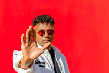 Man in glasses making stop gesture with palm of hand isolated. African american man making stop gesture with palm of hand isolated