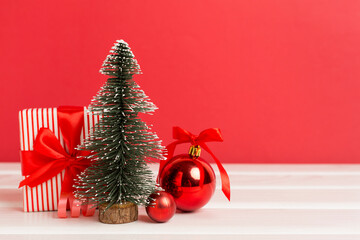 Miniature christmas tree with gift boxes and decor on table