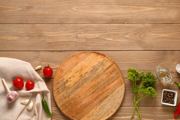 Composition with kitchen board, vegetables and spices on wooden background