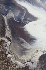 Aerial view with water with dirt and sand and fluid.