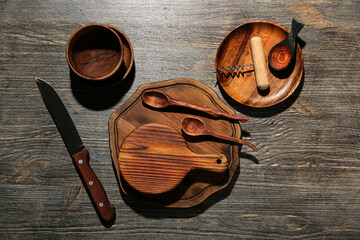 New cutting boards, bowls, knife and plate on wooden background