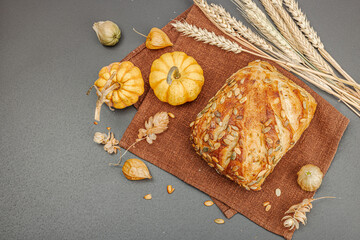 Fresh bread with pumpkin seeds. Home baking concept. Autumn decor