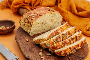 Fresh bread with pumpkin seeds. Home baking concept. Autumn decor