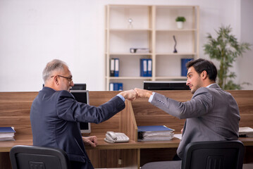 Two male colleagues working in the office
