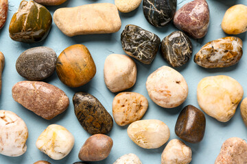 Many pebble stones on blue background