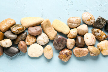 Many pebble stones on blue background
