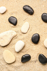 Fototapeta na wymiar Many pebble stones on sand