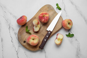 Wooden board with sweet fig peaches and mint on white background