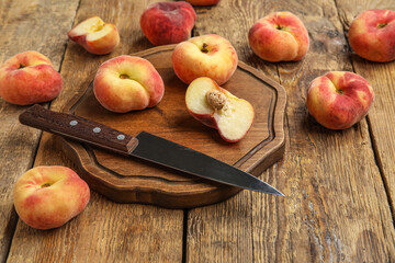 Board with sweet fig peaches on wooden background