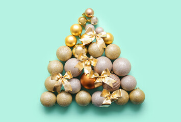 Christmas balls and bows in shape of tree on turquoise background