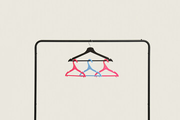 Rack with plastic clothes hangers on grey background