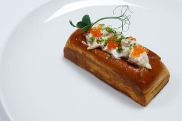 lobster roll, mixture of prawns and lobster meat with avocado in a bread roll with white background