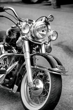 Classic Black American motorcycle parked on road.